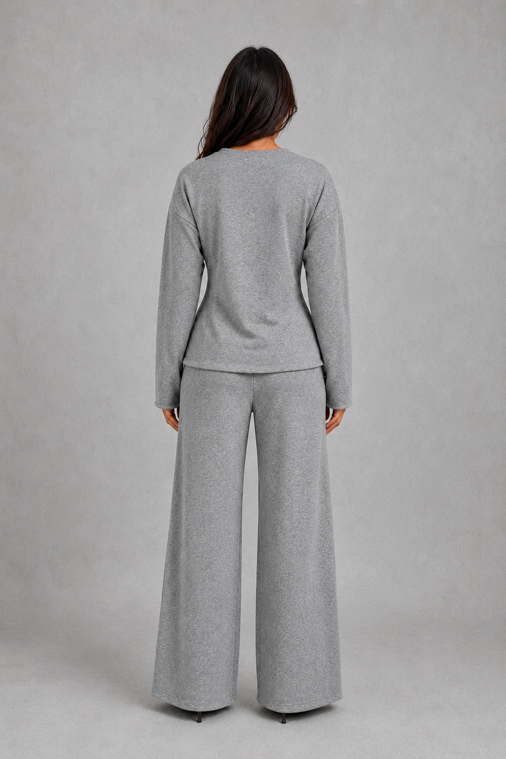 Women’s two-piece lounge set featuring a softly fitted long-sleeve crew neck top with a shaped waist and matching wide-leg pants with side pockets.