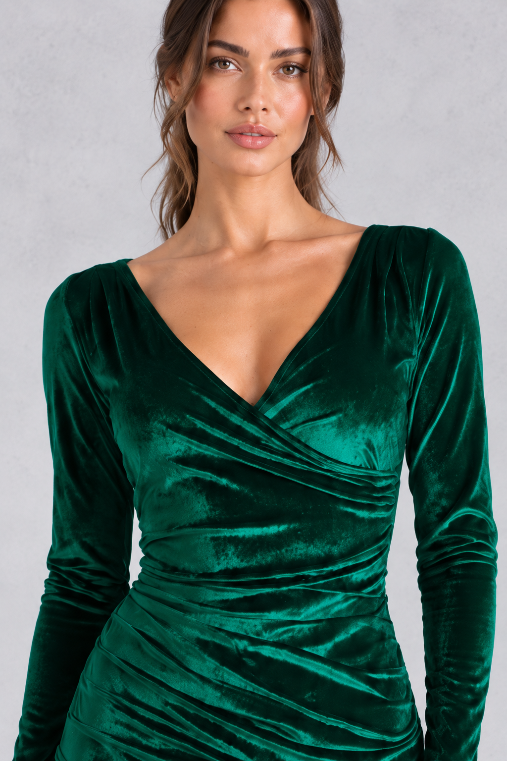 Model in a fitted velvet bodycon dress styled with ankle boots for a winter date night.