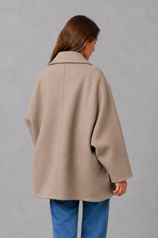 Women’s vintage-inspired longline coat with a relaxed silhouette, durable woven construction and practical front pockets for everyday layering.