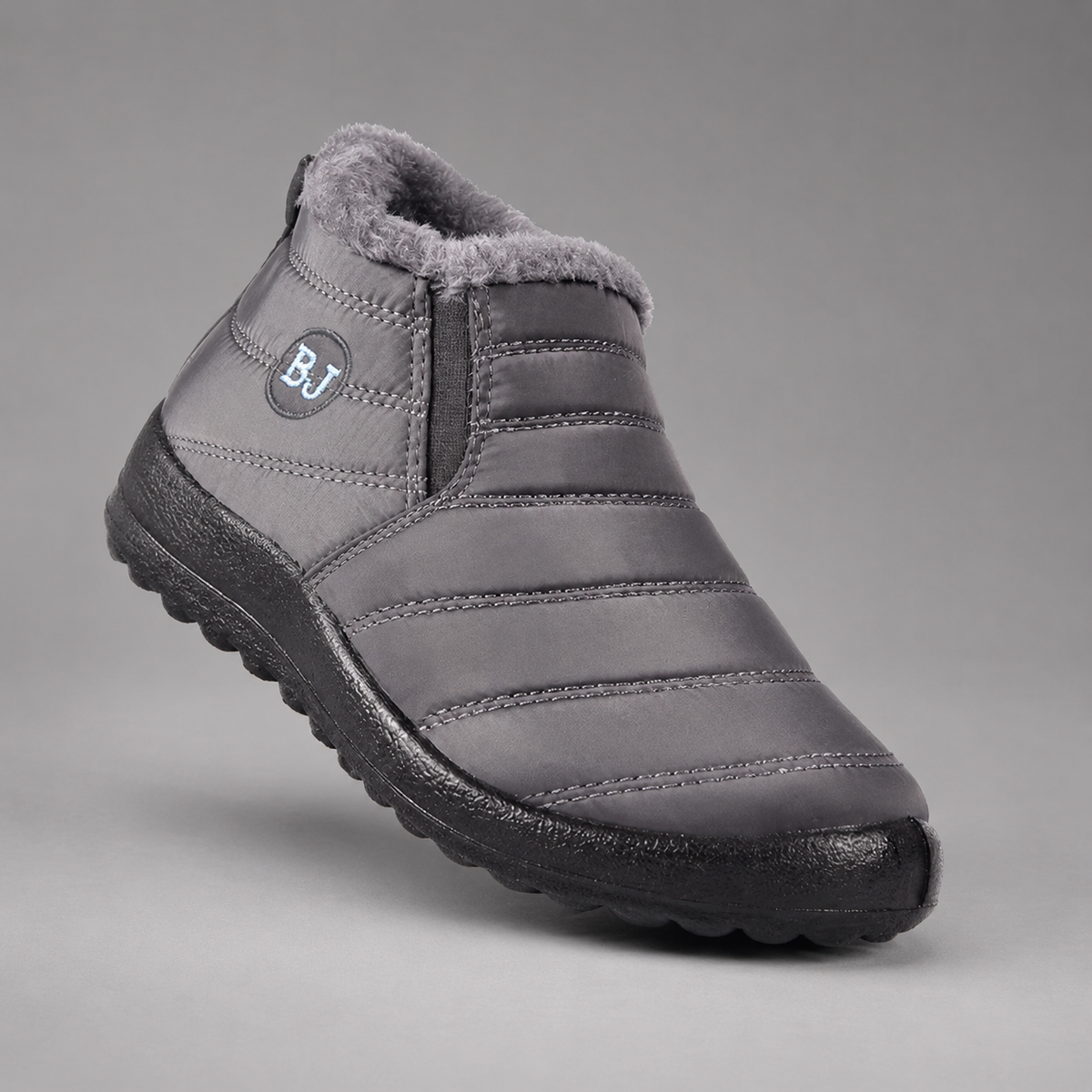 Women’s waterproof snow boots with a quilted upper, warm faux fur lining, round toe, slip-on design, and durable non-slip outsole.