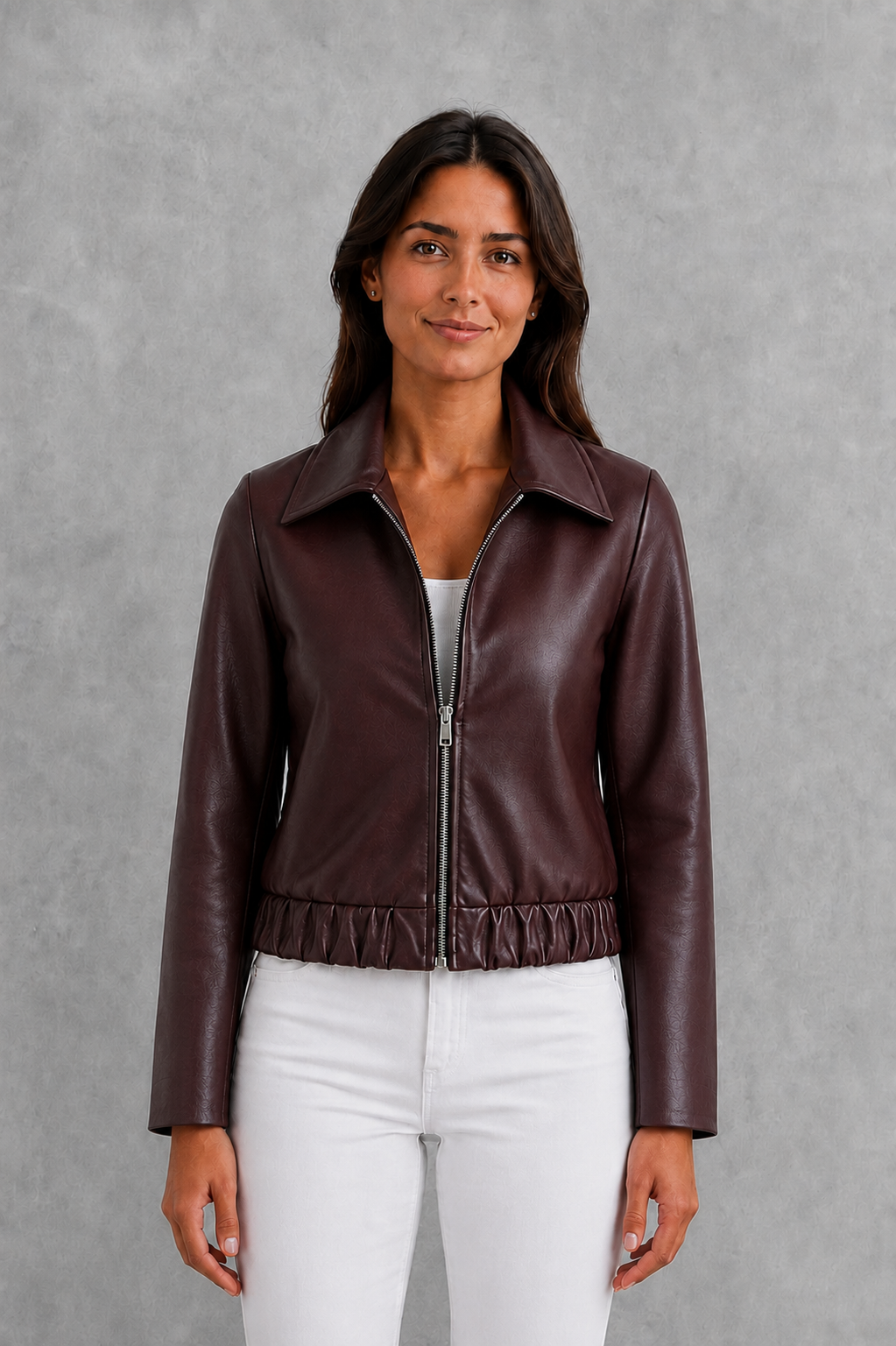 Women’s wine faux leather biker jacket with a smooth leather-look finish, zip-front closure, structured tailored fit, and streamlined moto-inspired silhouette.