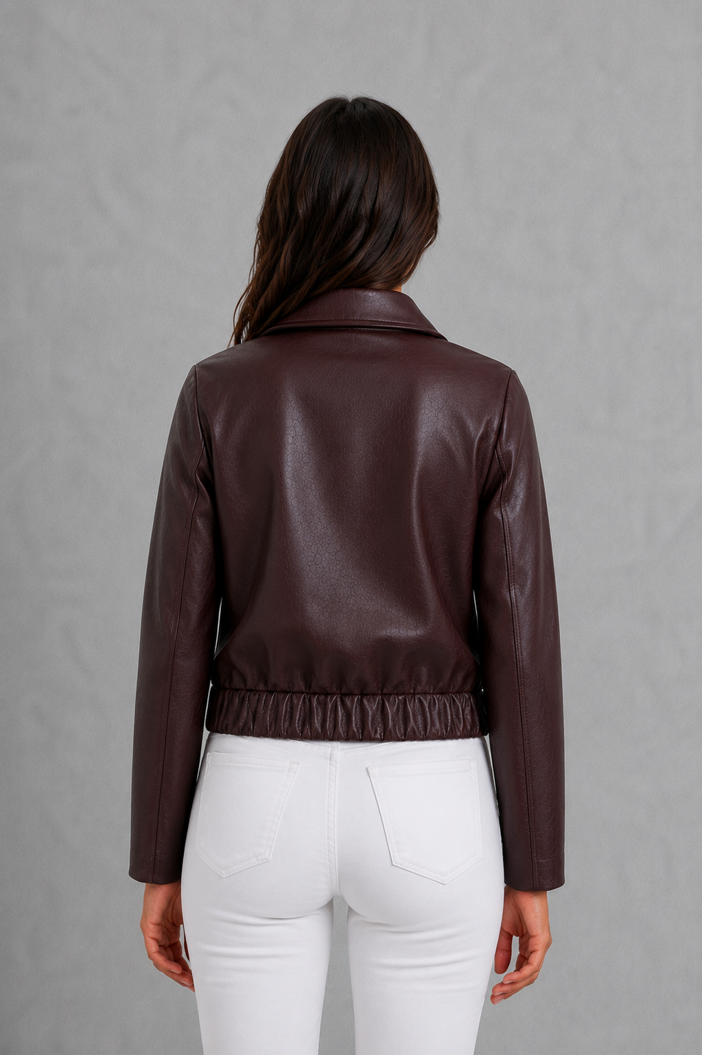 Women’s wine faux leather biker jacket with a smooth leather-look finish, zip-front closure, structured tailored fit, and streamlined moto-inspired silhouette.