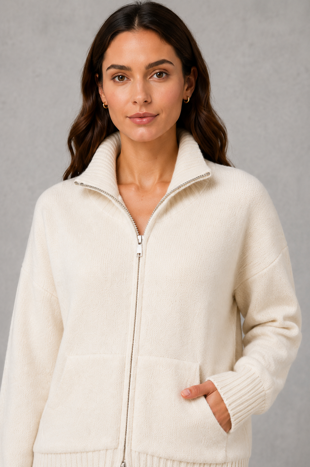 Women’s zip-up funnel neck cardigan with soft knit fabric, full front zipper, patch pockets, long sleeves, and ribbed cuffs and hem.