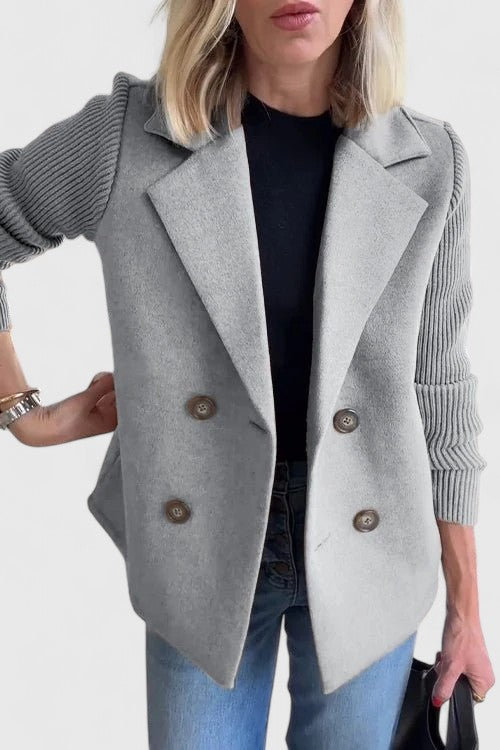 Women’s tailored blazer jacket with contrast sleeves and double-breasted front.