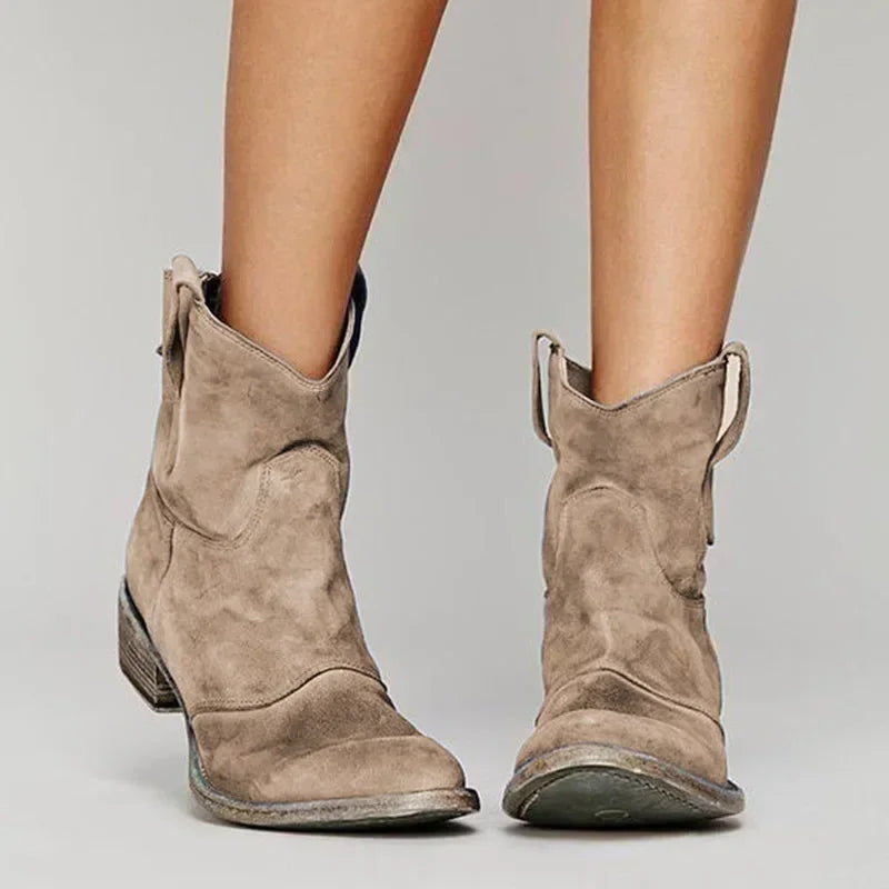 Women’s vintage western ankle boots with pointed toe and classic stitching.