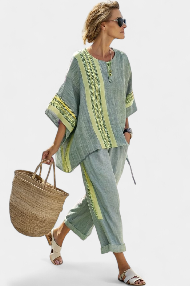 Women’s two-piece outfit featuring an asymmetrical blouse with embroidery and relaxed wide-leg pants designed for lightweight summer wear.