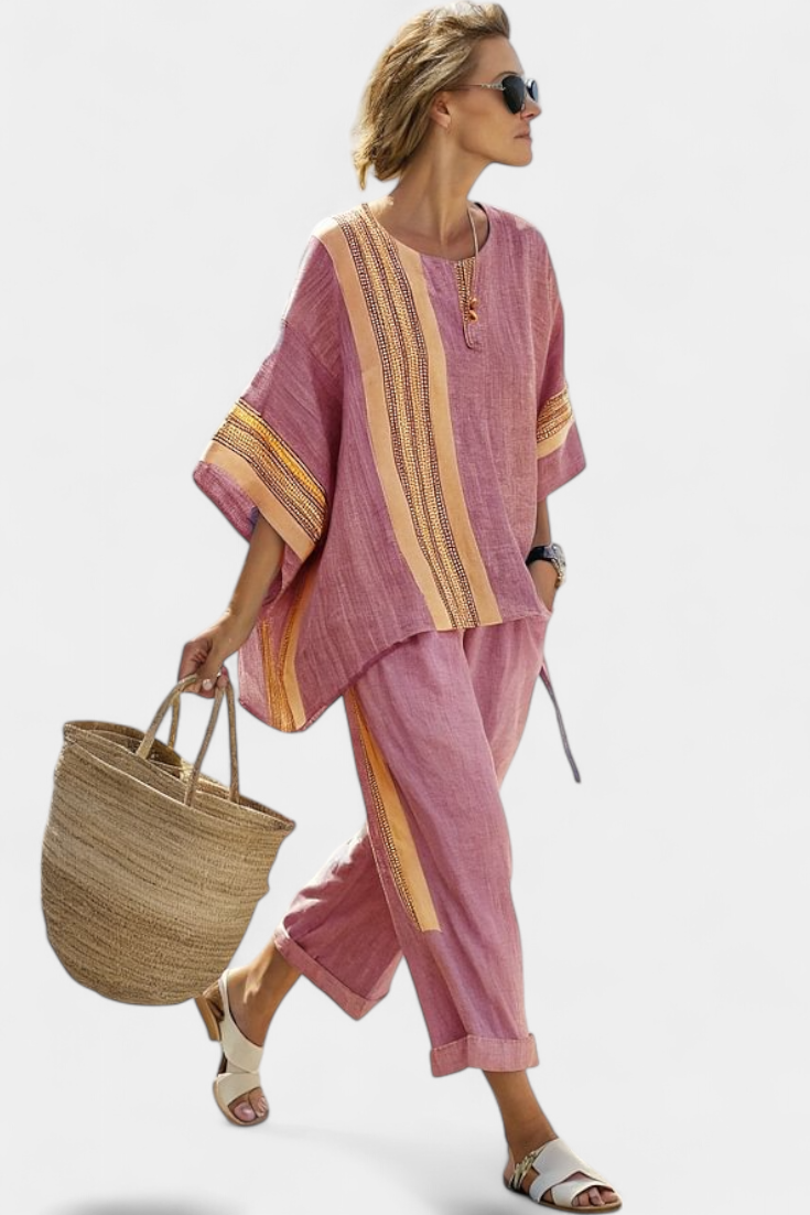 Women’s two-piece outfit featuring an asymmetrical blouse with embroidery and relaxed wide-leg pants designed for lightweight summer wear.