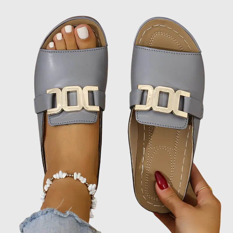 Women’s open-toe buckle sandals with cushioned insole and slip-on design for comfortable everyday wear.