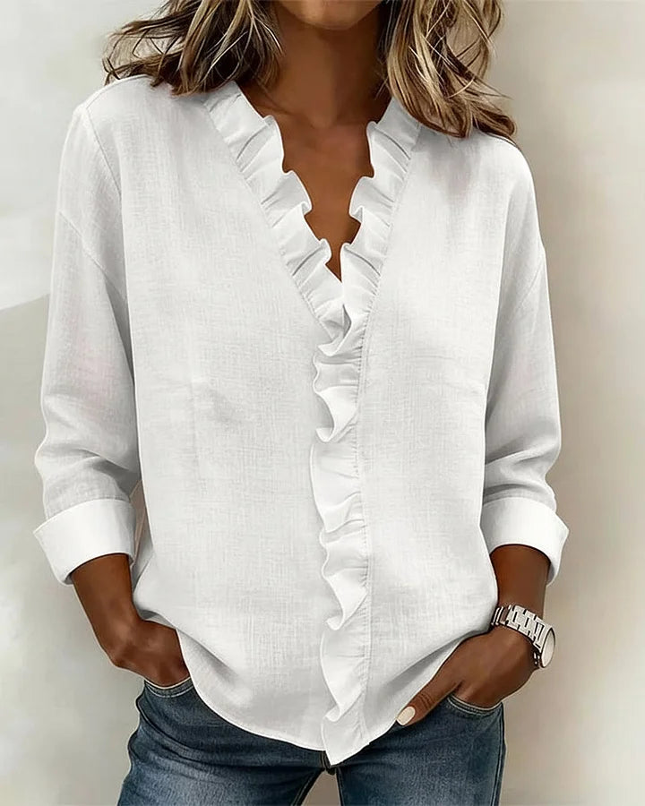 Women’s lightweight blouse with ruffled V-neckline, long sleeves, and clear cuffs, providing a relaxed, flattering silhouette for everyday wear.