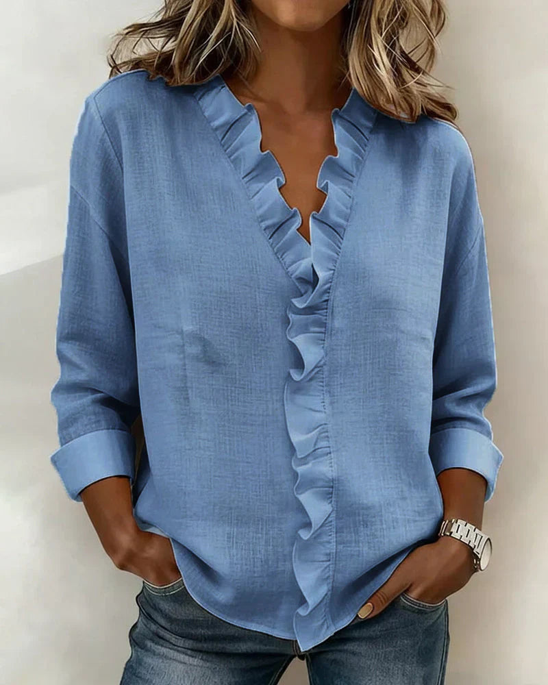 Women’s lightweight blouse with ruffled V-neckline, long sleeves, and clear cuffs, providing a relaxed, flattering silhouette for everyday wear.