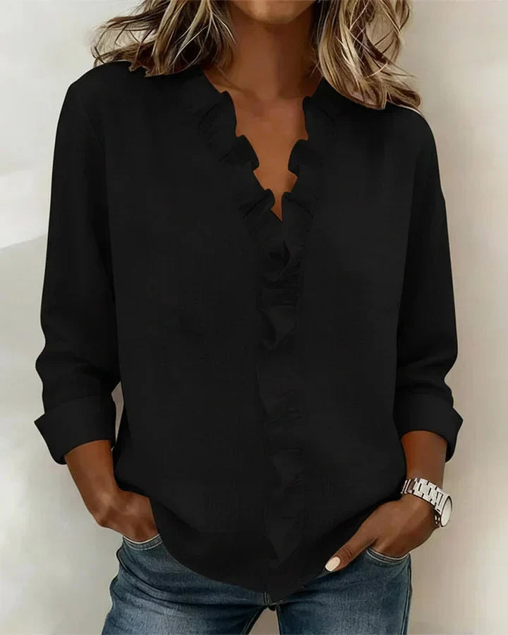 Women’s lightweight blouse with ruffled V-neckline, long sleeves, and clear cuffs, providing a relaxed, flattering silhouette for everyday wear.