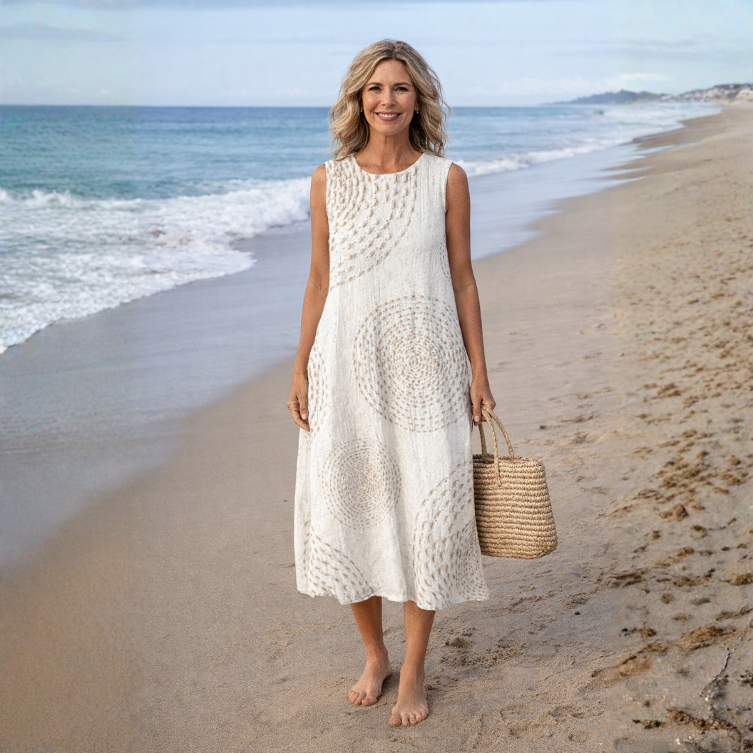 Women’s sleeveless printed midi dress with round neckline and side pockets in lightweight fabric for comfortable spring and summer wear.
