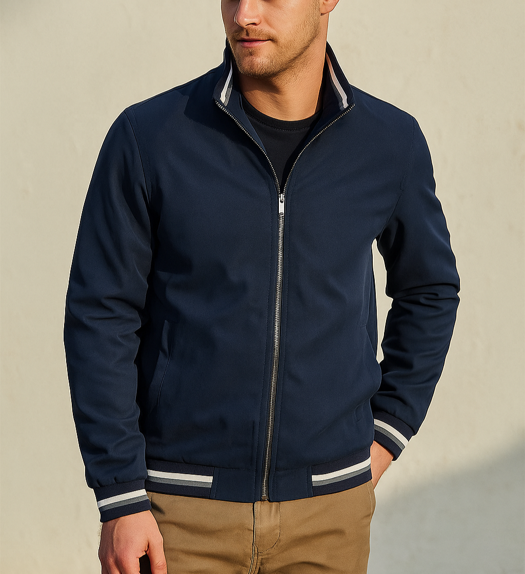 Man wearing a navy blue jacket with white trim on a beige background