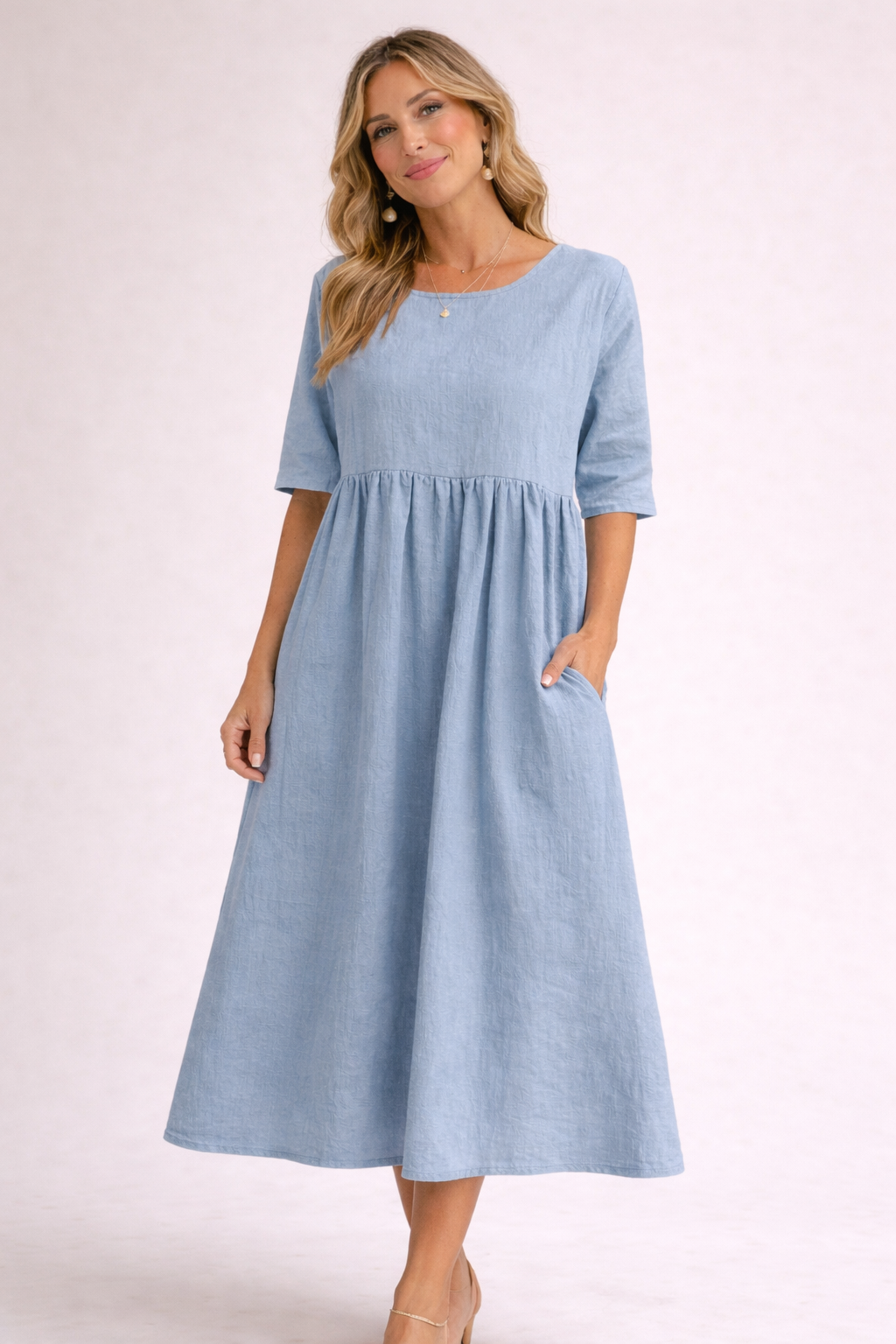 Woman wearing a light blue dress on a white background