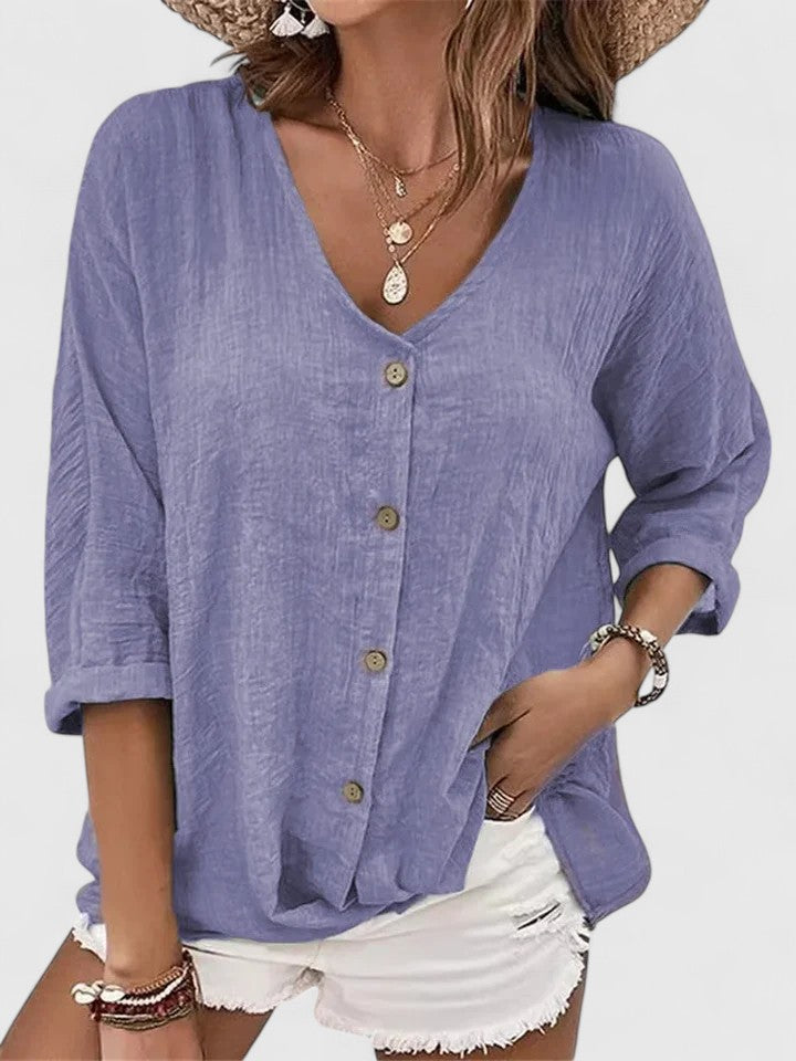 Women wearing a lightweight V-neck blouse with button detail