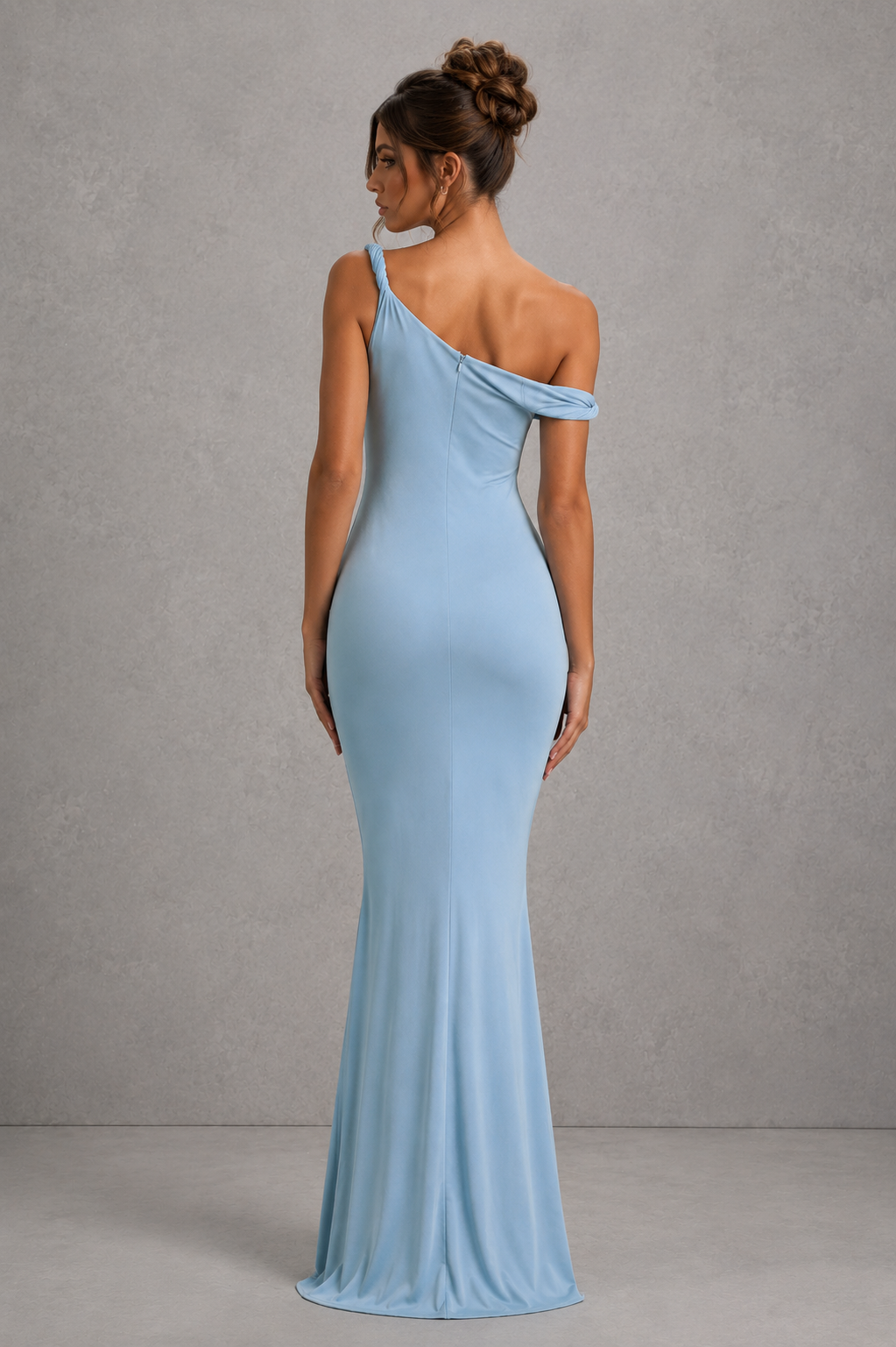 Woman wearing a women’s asymmetric bodycon maxi dress in premium double-layered stretch jersey with a twisted one-shoulder neckline, sleeveless fitted silhouette, and floor-length design for evening and formal occasions.