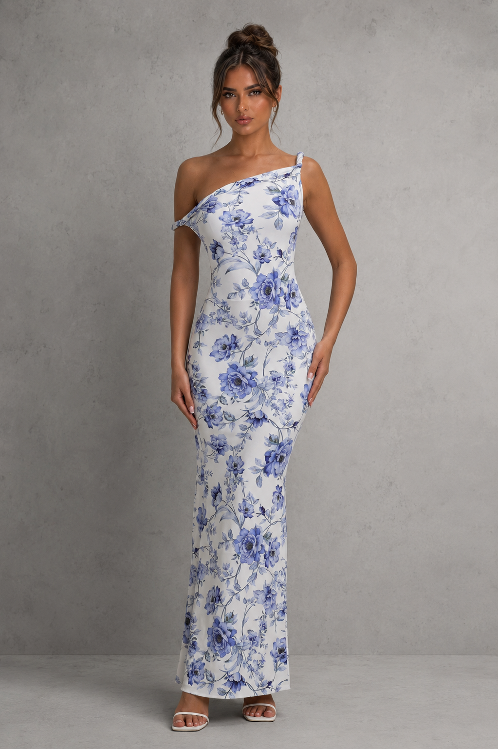 Woman wearing a women’s asymmetric bodycon maxi dress in premium double-layered stretch jersey with a twisted one-shoulder neckline, sleeveless fitted silhouette, and floor-length design for evening and formal occasions.