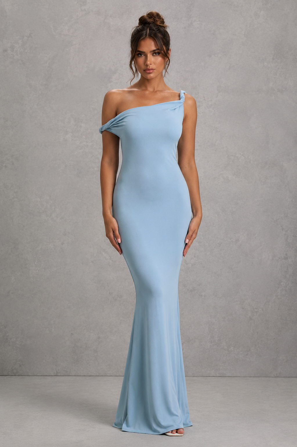 Woman wearing a women’s asymmetric bodycon maxi dress in premium double-layered stretch jersey with a twisted one-shoulder neckline, sleeveless fitted silhouette, and floor-length design for evening and formal occasions.