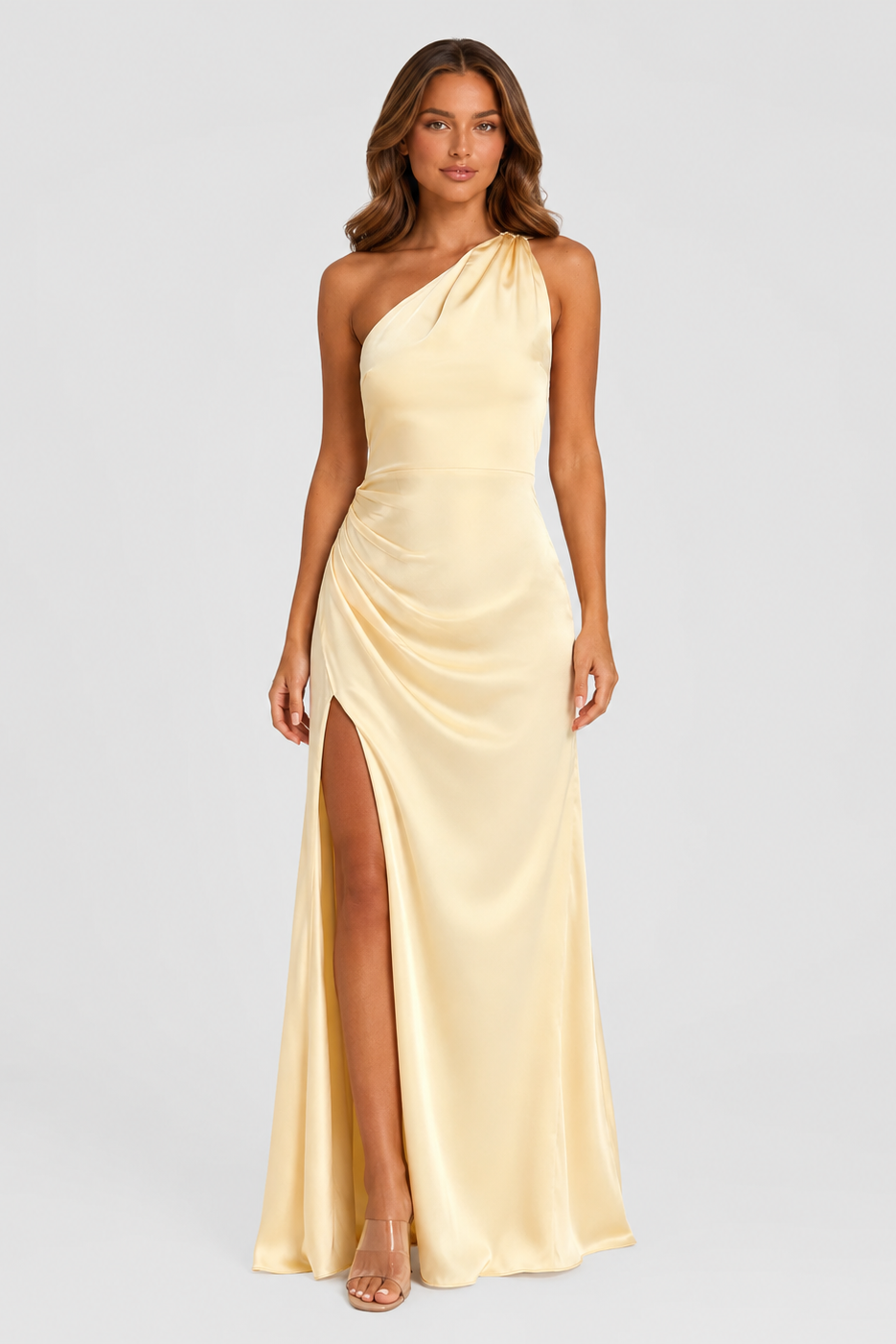 Women's asymmetric maxi dress in a soft beige tone featuring a one-shoulder neckline, flowing silhouette, and elegant side split for formal occasions and evening wear.