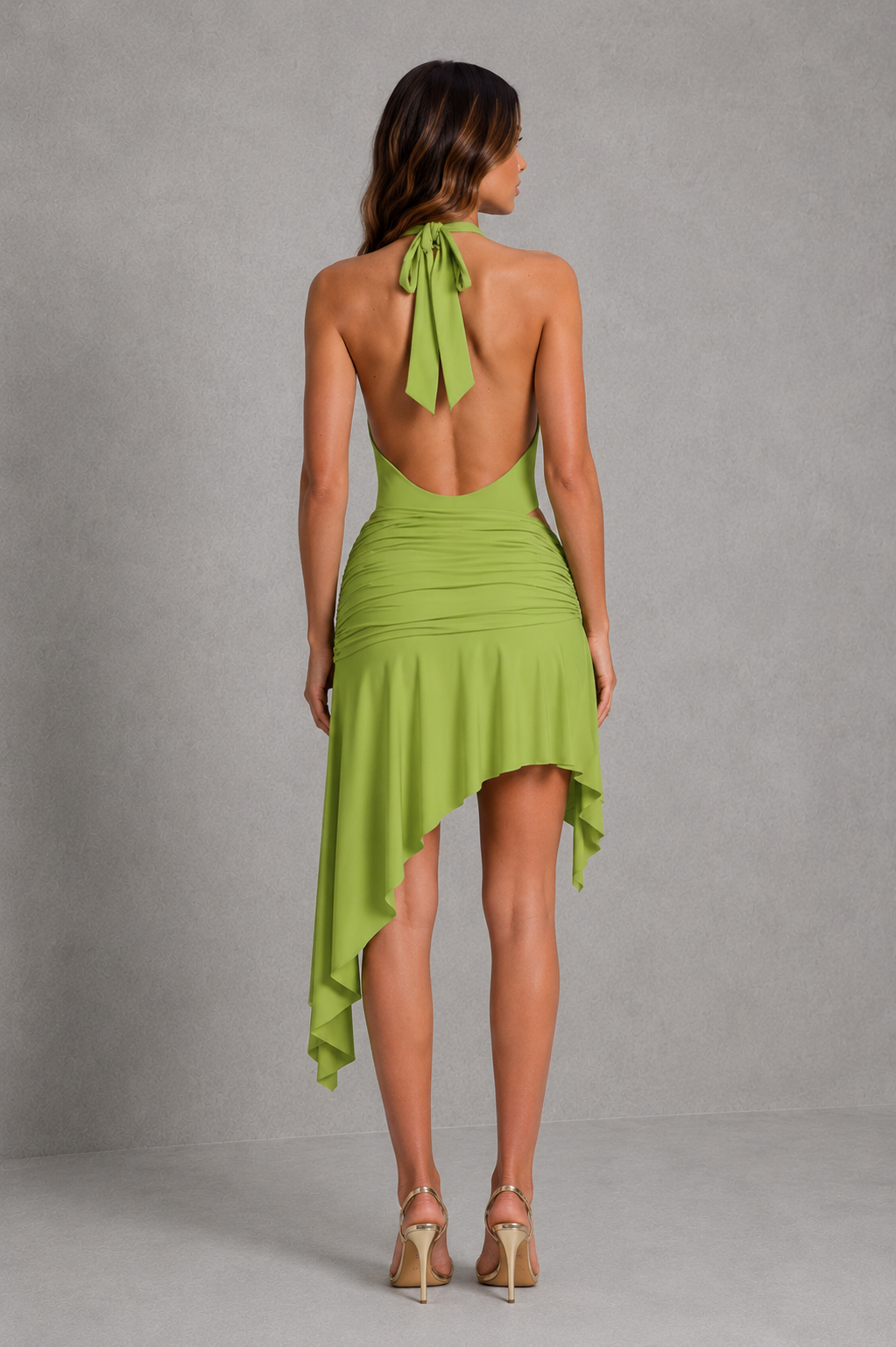 Women’s asymmetric ruched mini skirt with twisted knot waist detail and flowing handkerchief hem in stretch slinky jersey.