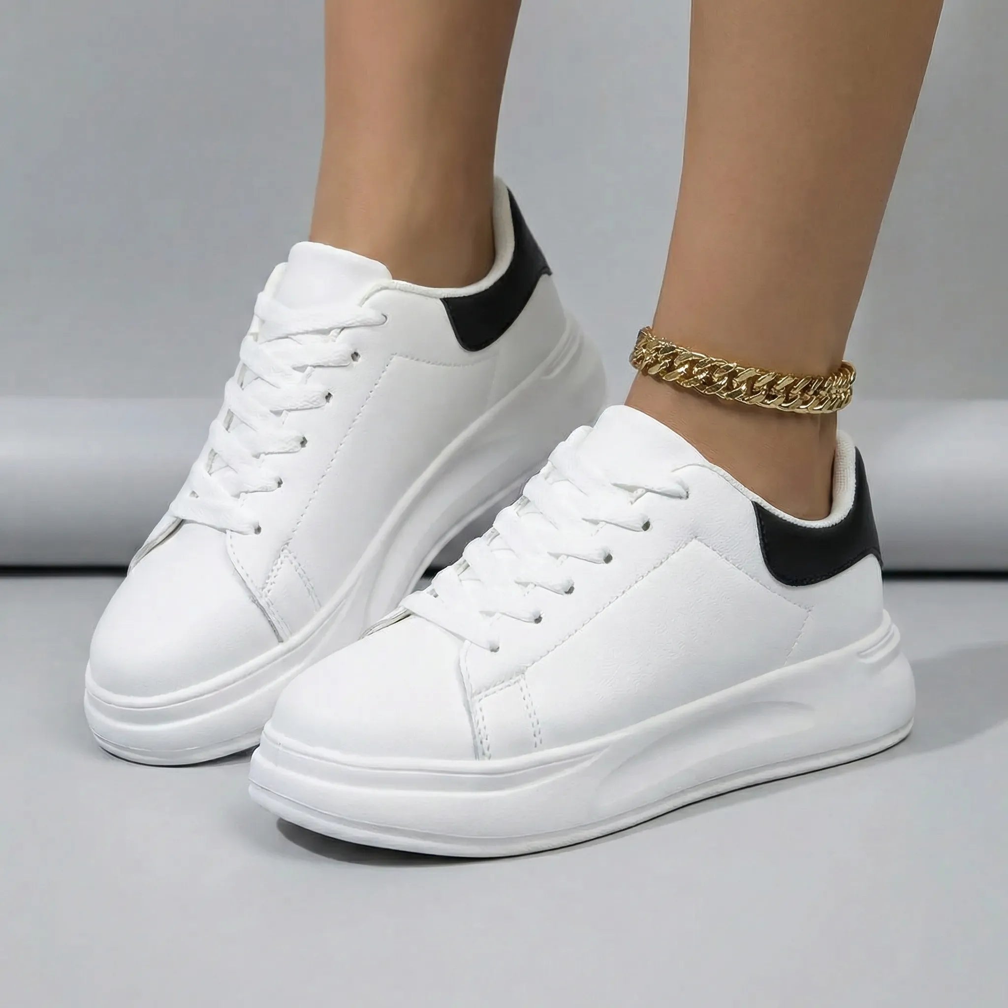 Women’s clean white casual sneakers with cushioned sole and lace-up closure