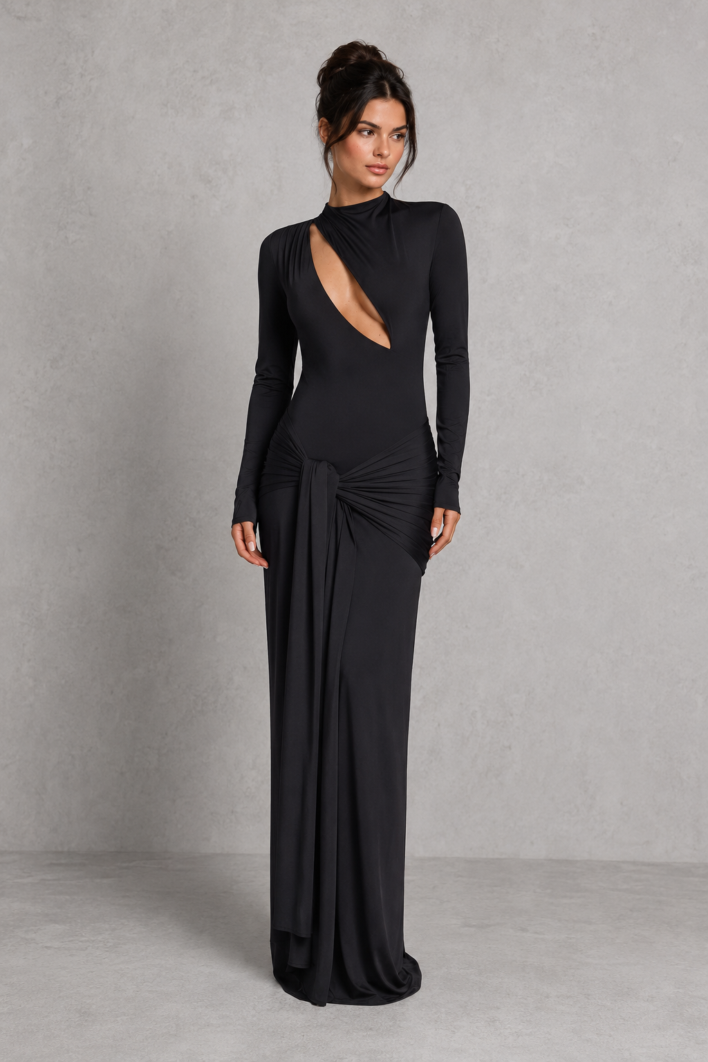 Women's black cut-out maxi dress with a high neckline, long sleeves, draped tie-front hip detail, and fitted stretch silhouette for evening and formal occasions.