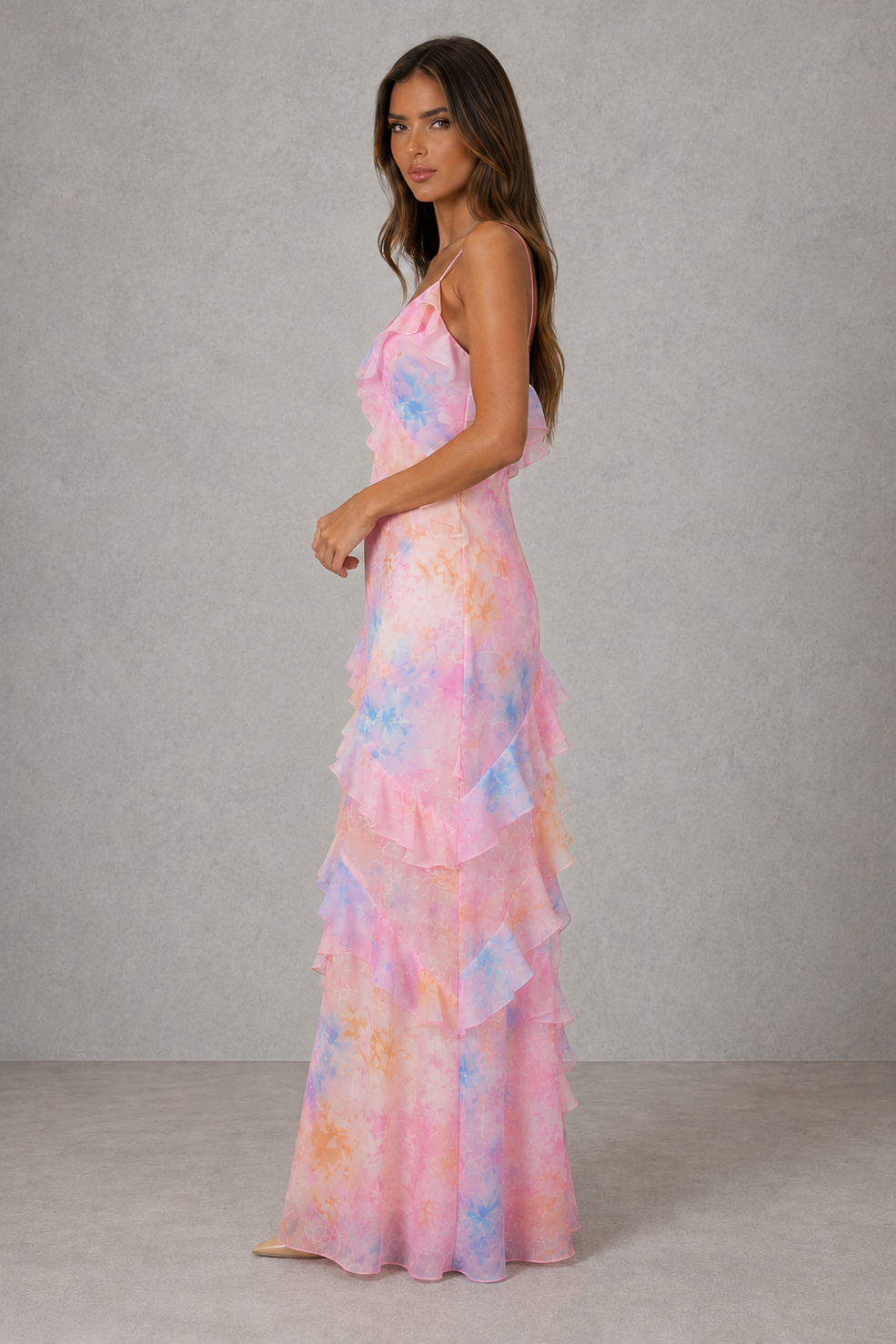 Women’s floral chiffon maxi dress with V-neckline, adjustable shoulder straps, soft pastel print and cascading ruffle detail for wedding guest wear.