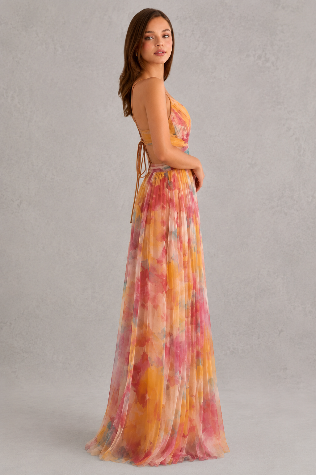 Women’s floral maxi dress by Klyne Studios featuring a flowing full-length silhouette, adjustable tie-back detail, lightweight breathable fabric, and relaxed fit for warm-weather styling.