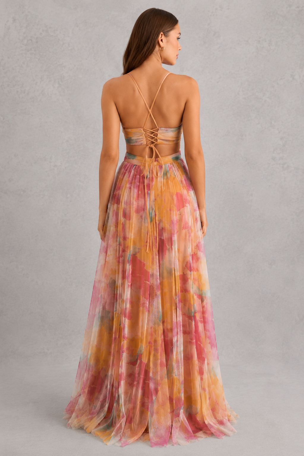 Women’s floral maxi dress by Klyne Studios featuring a flowing full-length silhouette, adjustable tie-back detail, lightweight breathable fabric, and relaxed fit for warm-weather styling.