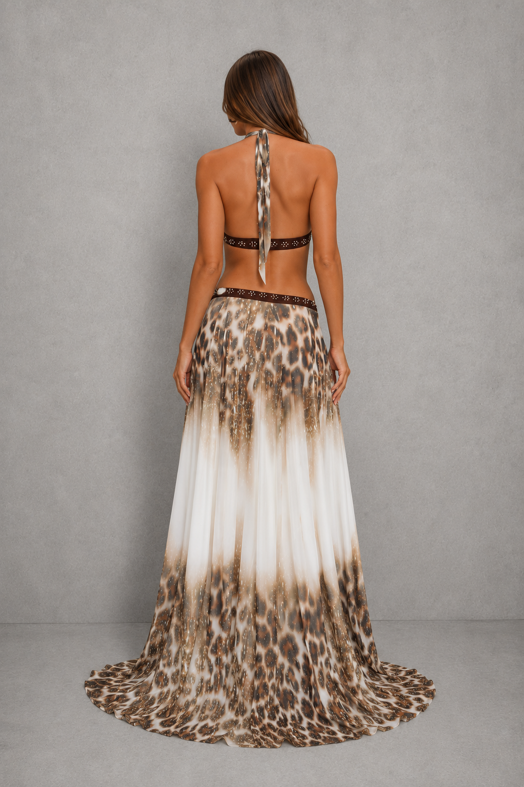 Women’s halter backless maxi dress with plunging neckline, beaded waist detailing, fitted silhouette, and flowing waterfall hem.