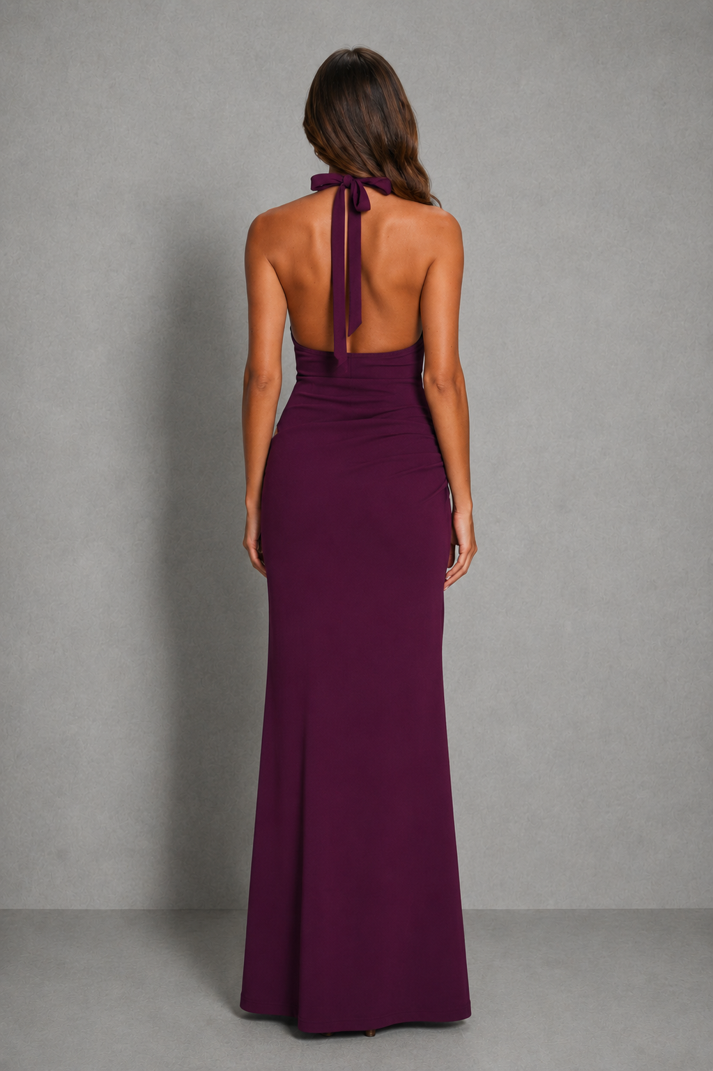 Women’s halter cut-out maxi dress with plunging neckline, asymmetrical waist detail, ruched hips, and a flowing floor-length skirt.