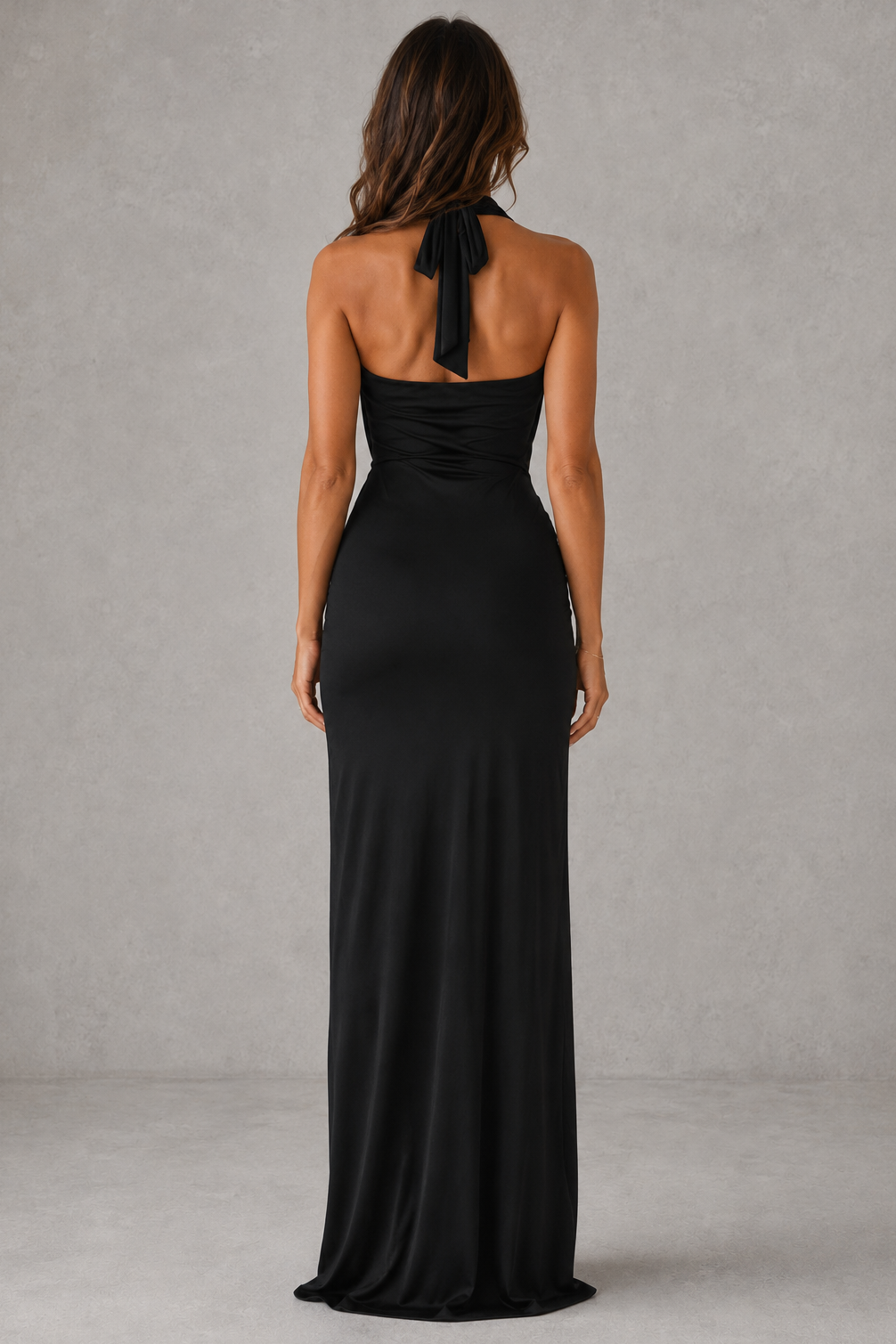 Women's halter maxi dress with a plunging cowl neckline, gathered twist waist, thigh-high split skirt, and flowing slinky jersey silhouette, designed for evening events, weddings, and formal occasions.
