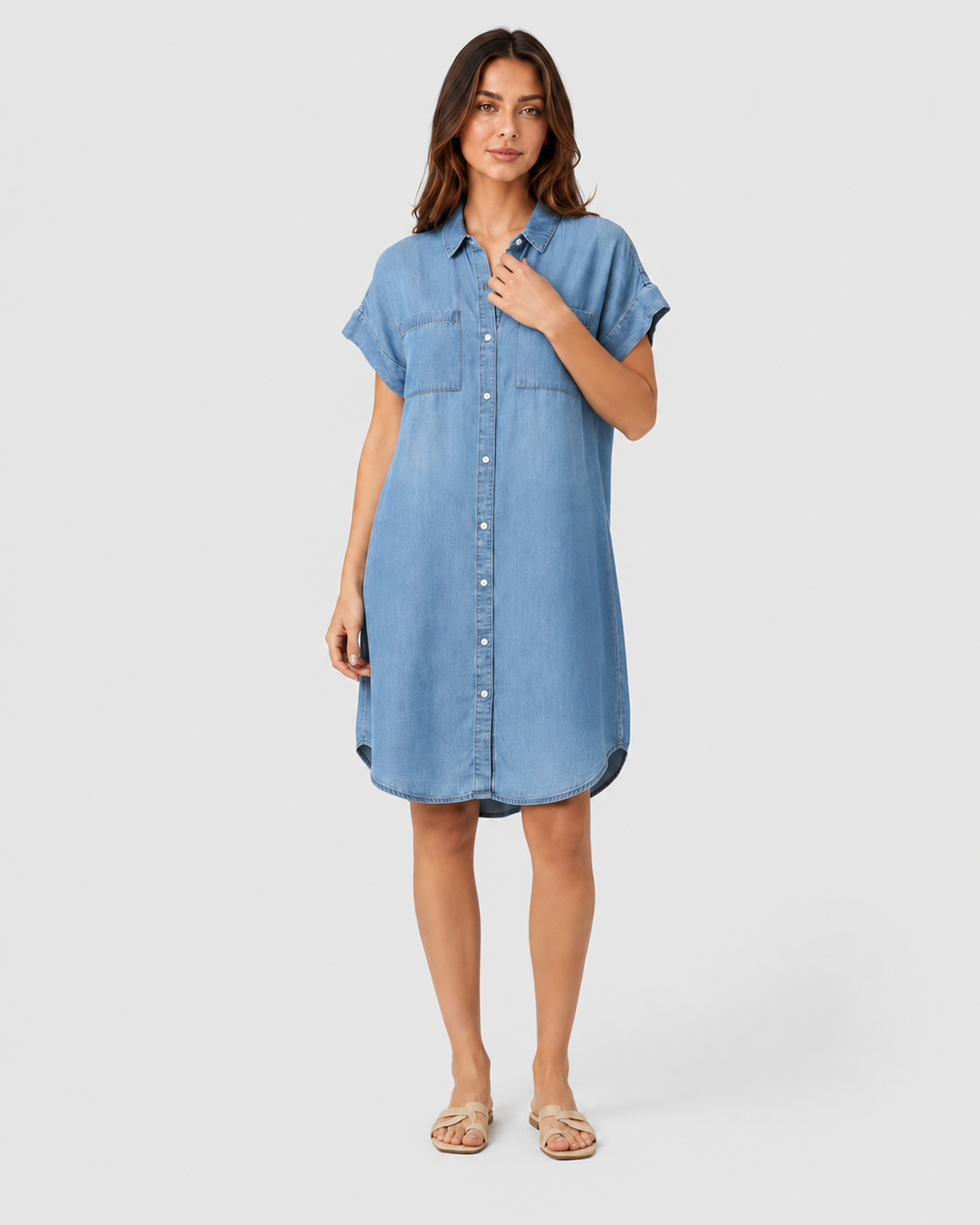 Woman wearing a light blue lightweight summer mini dress with a relaxed fit against a neutral background.