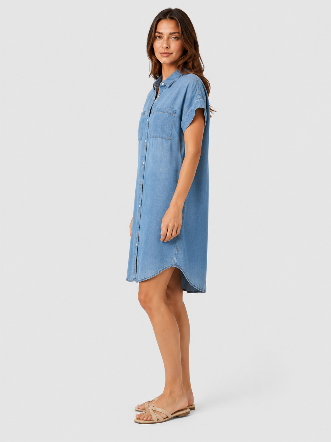 Woman wearing a light blue lightweight summer mini dress with a relaxed fit against a neutral background.
