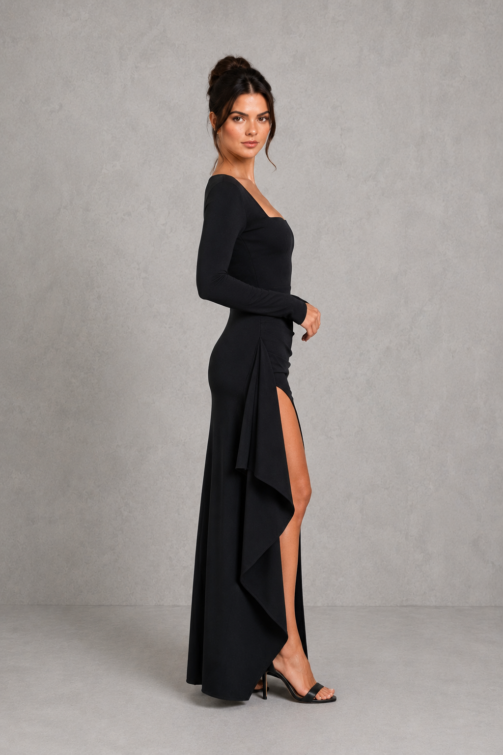 Women's long sleeve maxi evening dress in luxury stretch crepe featuring a fitted silhouette, pleated waist, draped thigh-high split, flared cuffs, and flowing skirt for formal occasions.