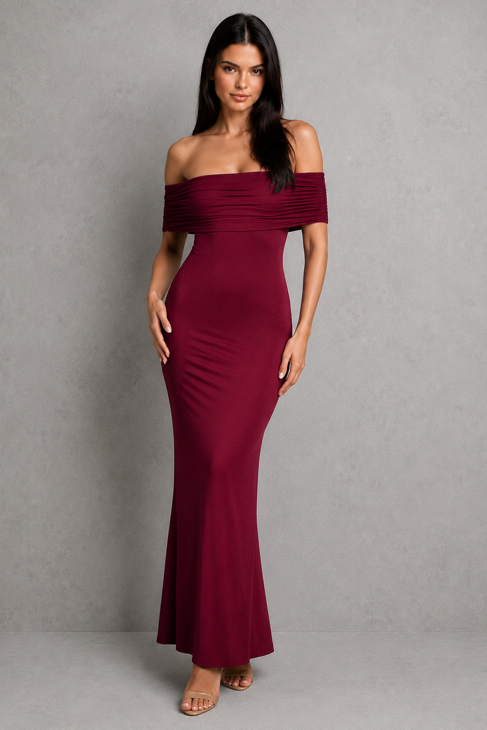 Woman wearing an elegant off-shoulder pleated maxi dress featuring a fitted bodice and flowing floor-length skirt, ideal for weddings, formal events, and evening occasions.