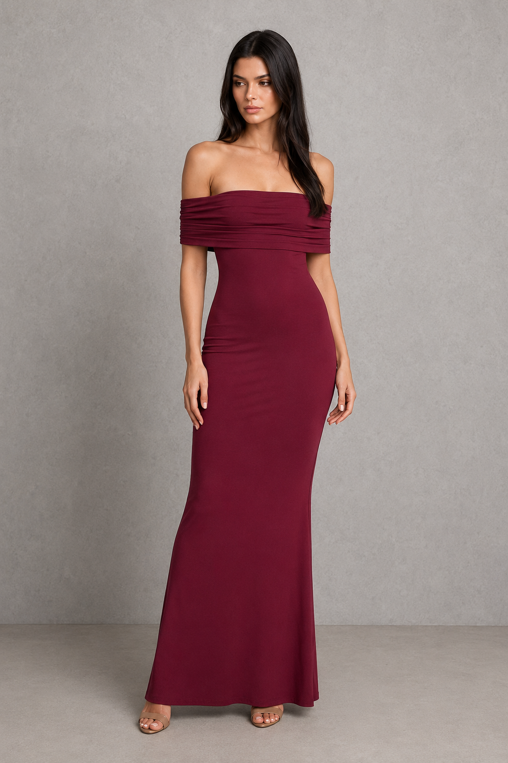 Woman wearing an elegant off-shoulder pleated maxi dress featuring a fitted bodice and flowing floor-length skirt, ideal for weddings, formal events, and evening occasions.