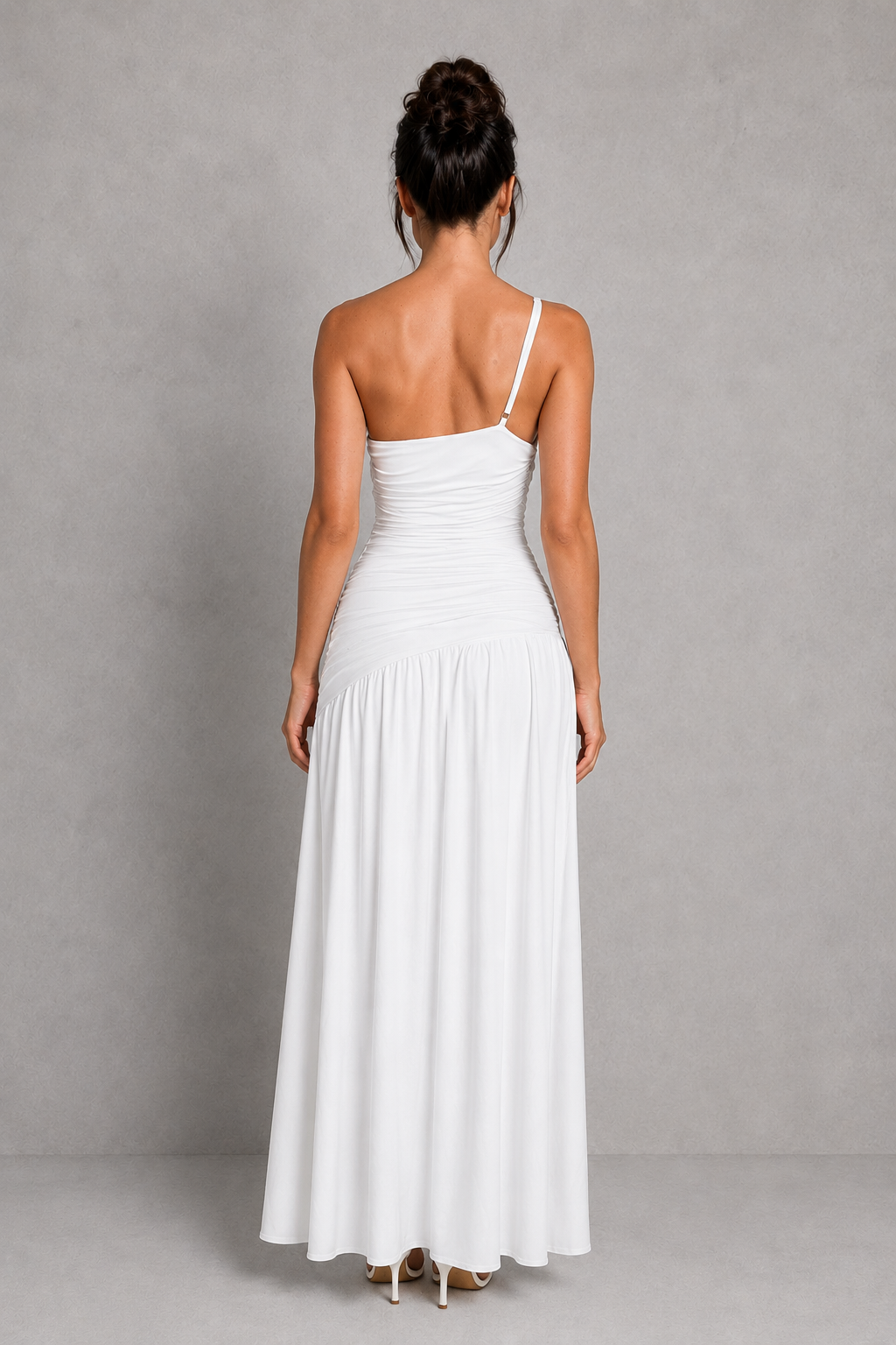 Woman wearing a one-shoulder maxi dress with gathered waist detailing, thigh-high split, and flowing skirt in premium slinky jersey for evening and formal occasions.