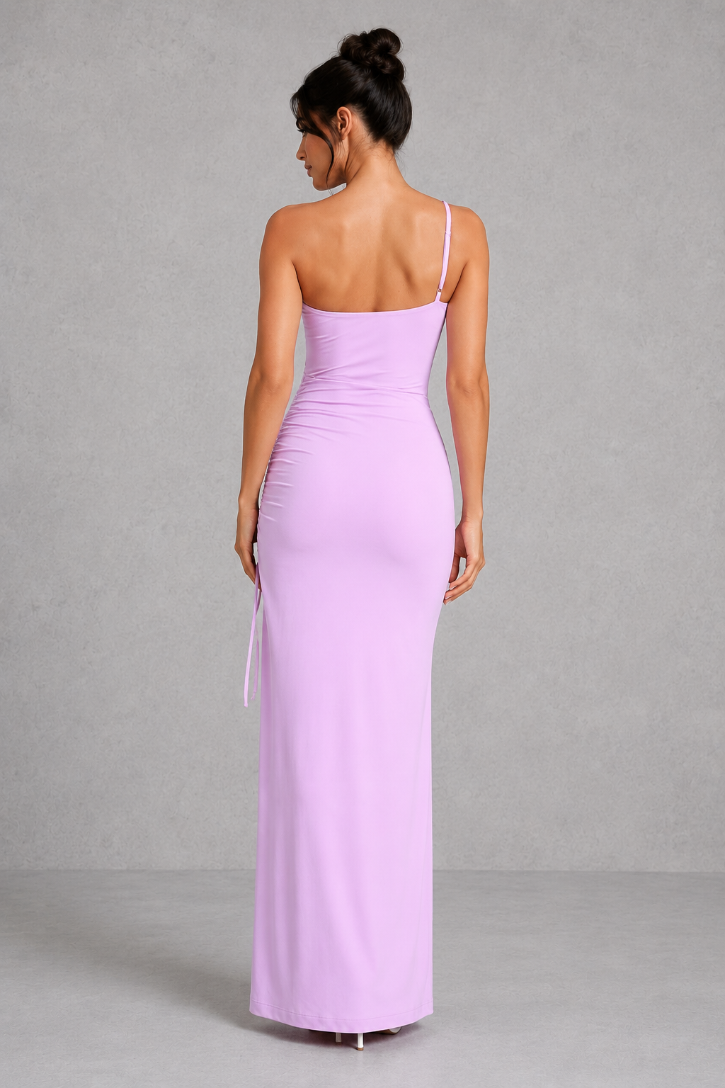 Woman wearing a one-shoulder ruched maxi dress with a thigh-high split and side tie detail, crafted from soft double-layered slinky fabric for an elegant evening and formal occasion look.