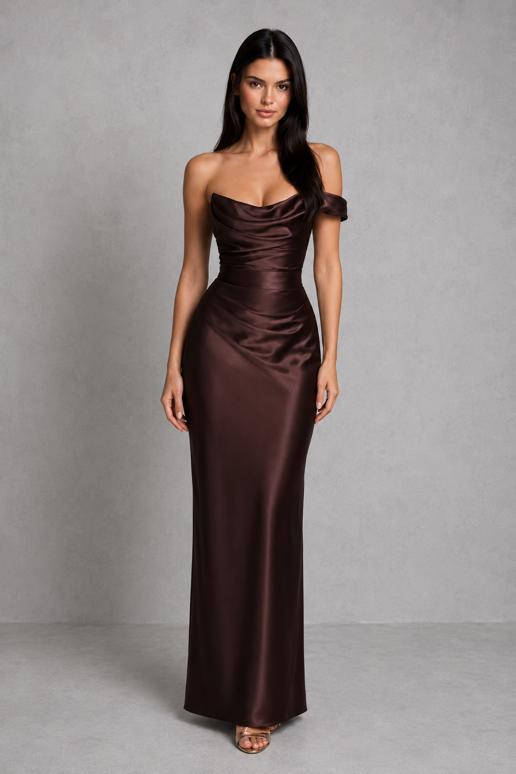 Woman wearing a one-shoulder satin maxi dress featuring a pleated cowl neckline, structured corset bodice with boning, asymmetrical draping, adjustable lace-up back, and a flowing bias-cut skirt, ideal for formal events, evening occasions, and special celebrations.