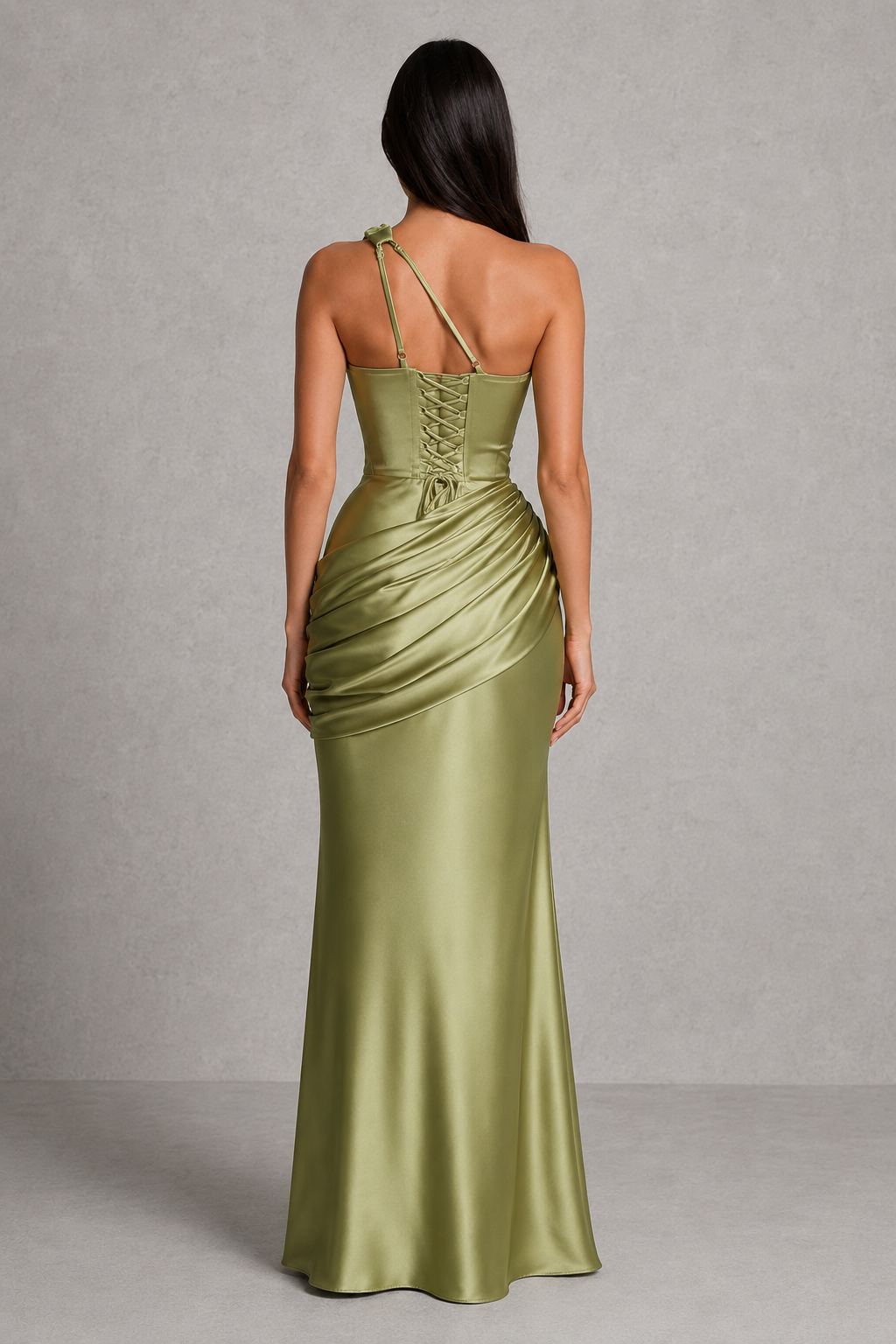 Woman wearing a one-shoulder satin maxi dress featuring a structured corset bodice, asymmetrical neckline, plunge cut-out detail, draped hip panel, and flowing bias-cut skirt, designed for elegant evening events and formal occasions.