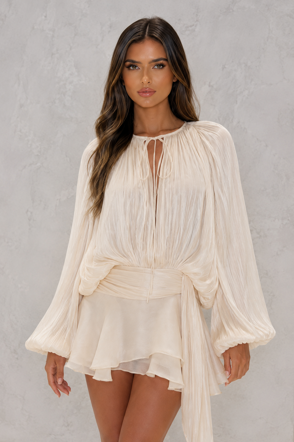 Women’s pearl pleated long sleeve mini dress with twist-front draping, neck tie, structured shoulders, and ruffled hem.