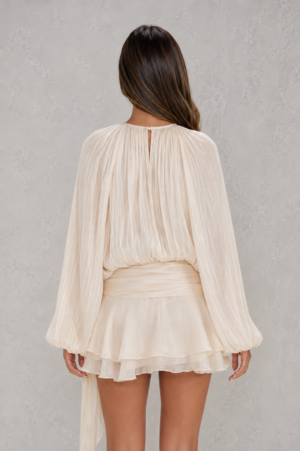 Women’s pearl pleated long sleeve mini dress with twist-front draping, neck tie, structured shoulders, and ruffled hem.