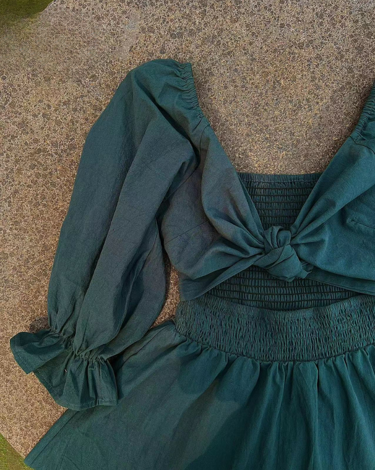 Women wearing midi dress with French ruffle sleeves and side cutout detail in slim fit silhouette