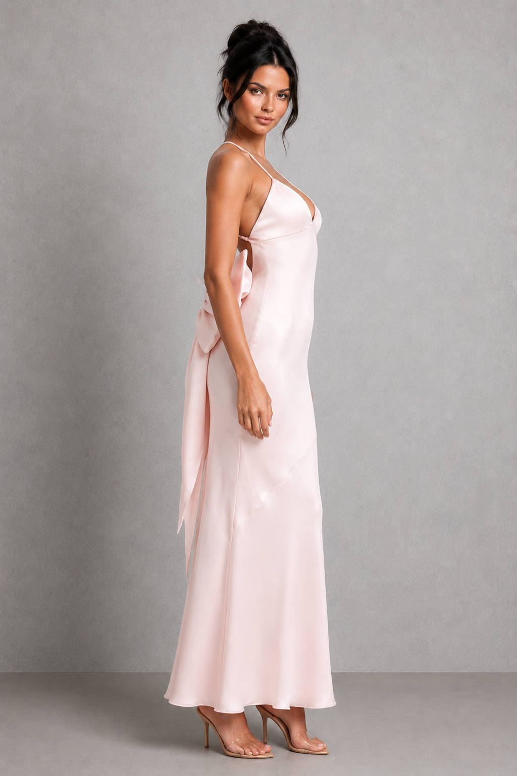Women's satin maxi dress featuring a fitted silhouette, triangle cup bodice, adjustable crossover straps, low V-shaped open back, and removable bow detail, ideal for bridal events, rehearsal dinners, and formal occasions.