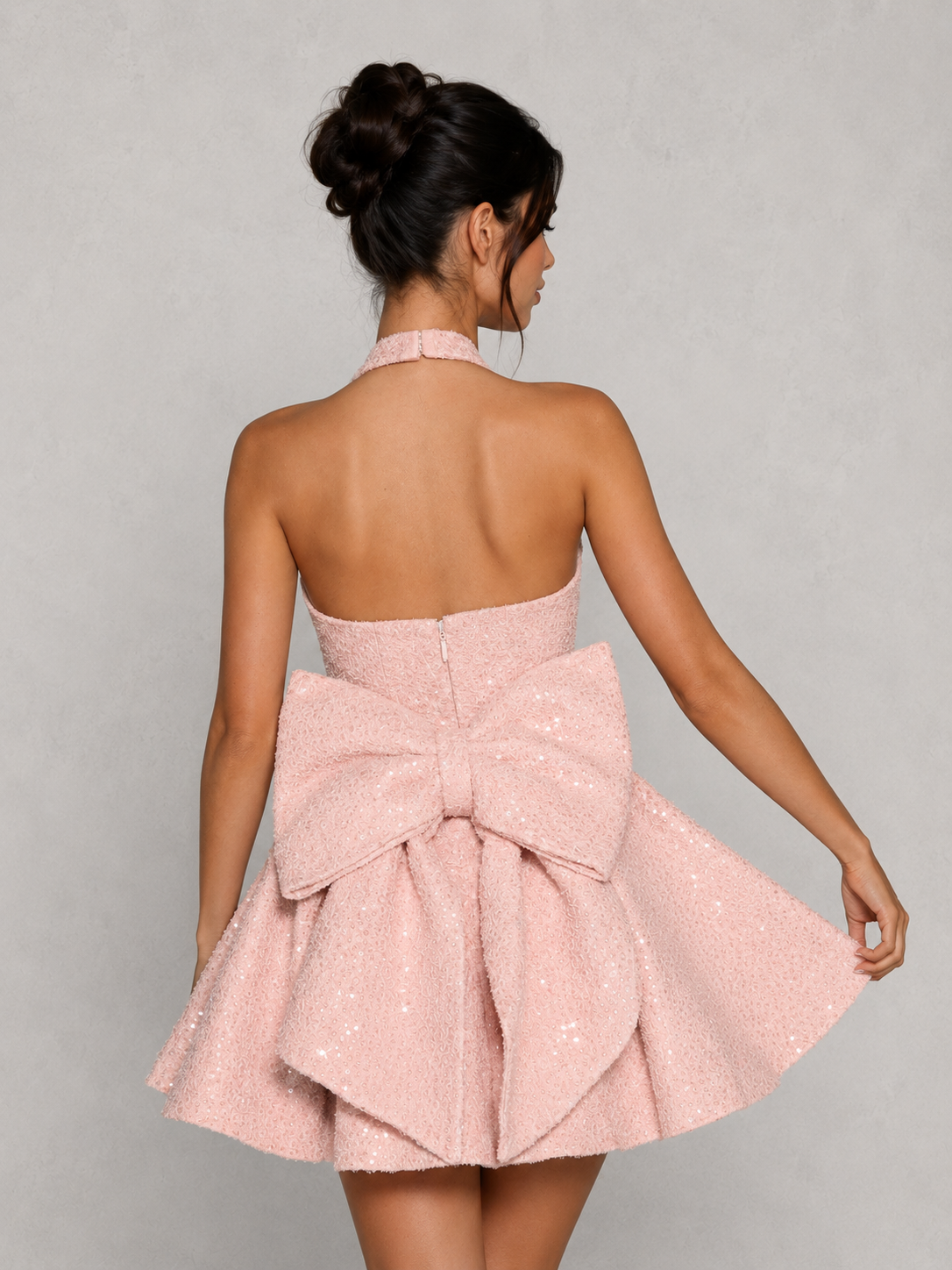 Women’s sequin tweed mini dress featuring a halter neckline, structured mono-underwire bodice, full circular skirt, and oversized detachable bow at the back, designed for parties, weddings, and special occasions.