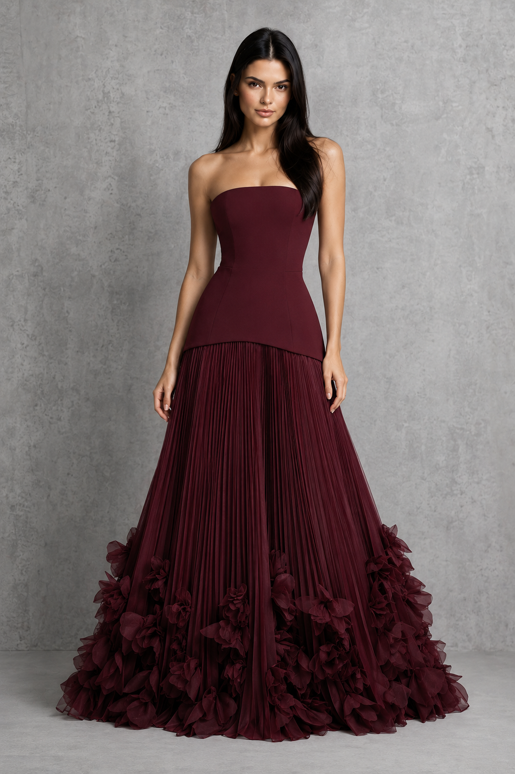 Women’s strapless corset gown with lace-up back, fitted bodice, full pleated skirt, and handcrafted floral appliqué detailing along the hem.
