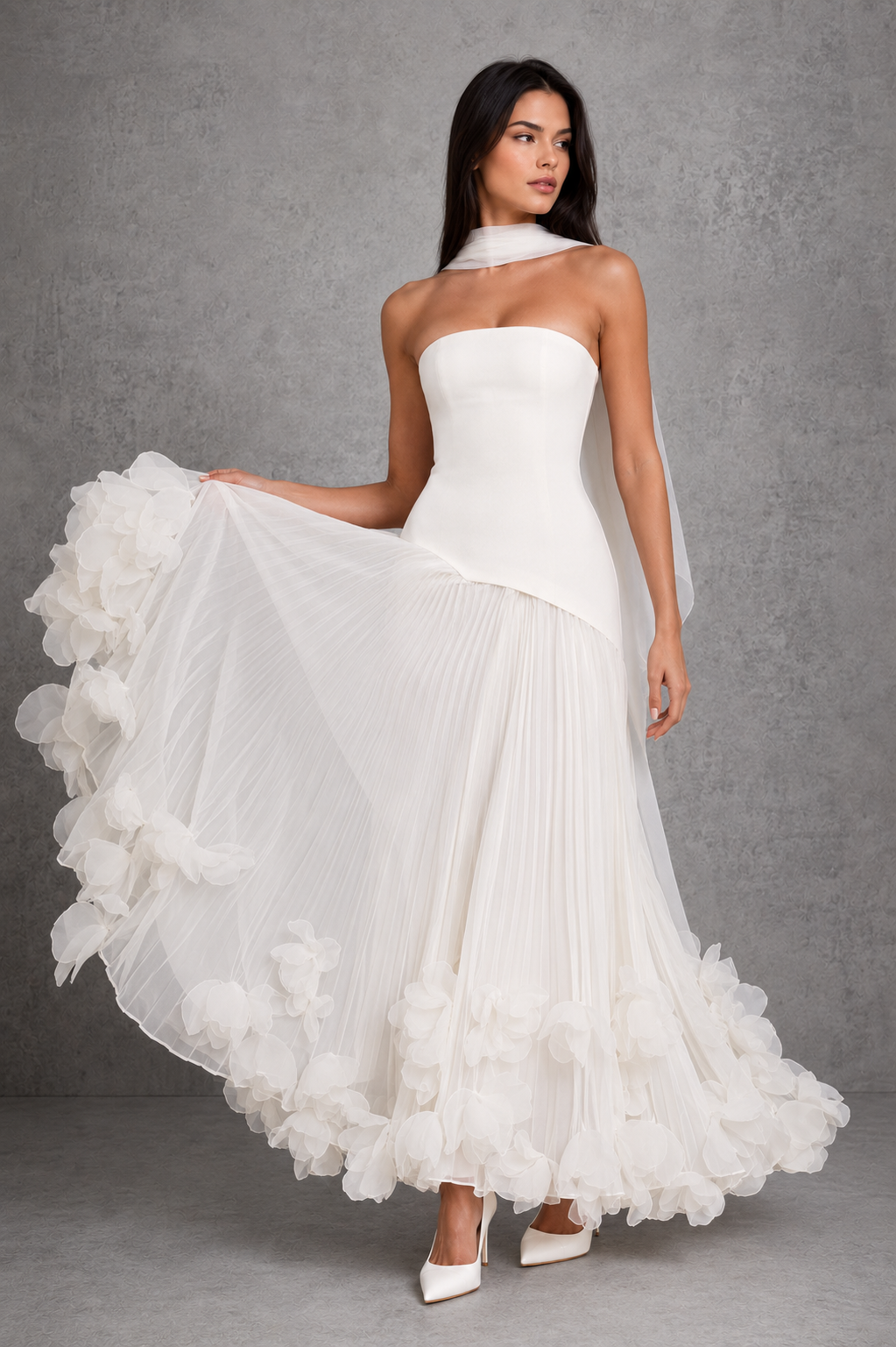 Women’s strapless corset gown with lace-up back, fitted bodice, full pleated skirt, and handcrafted floral appliqué detailing along the hem.