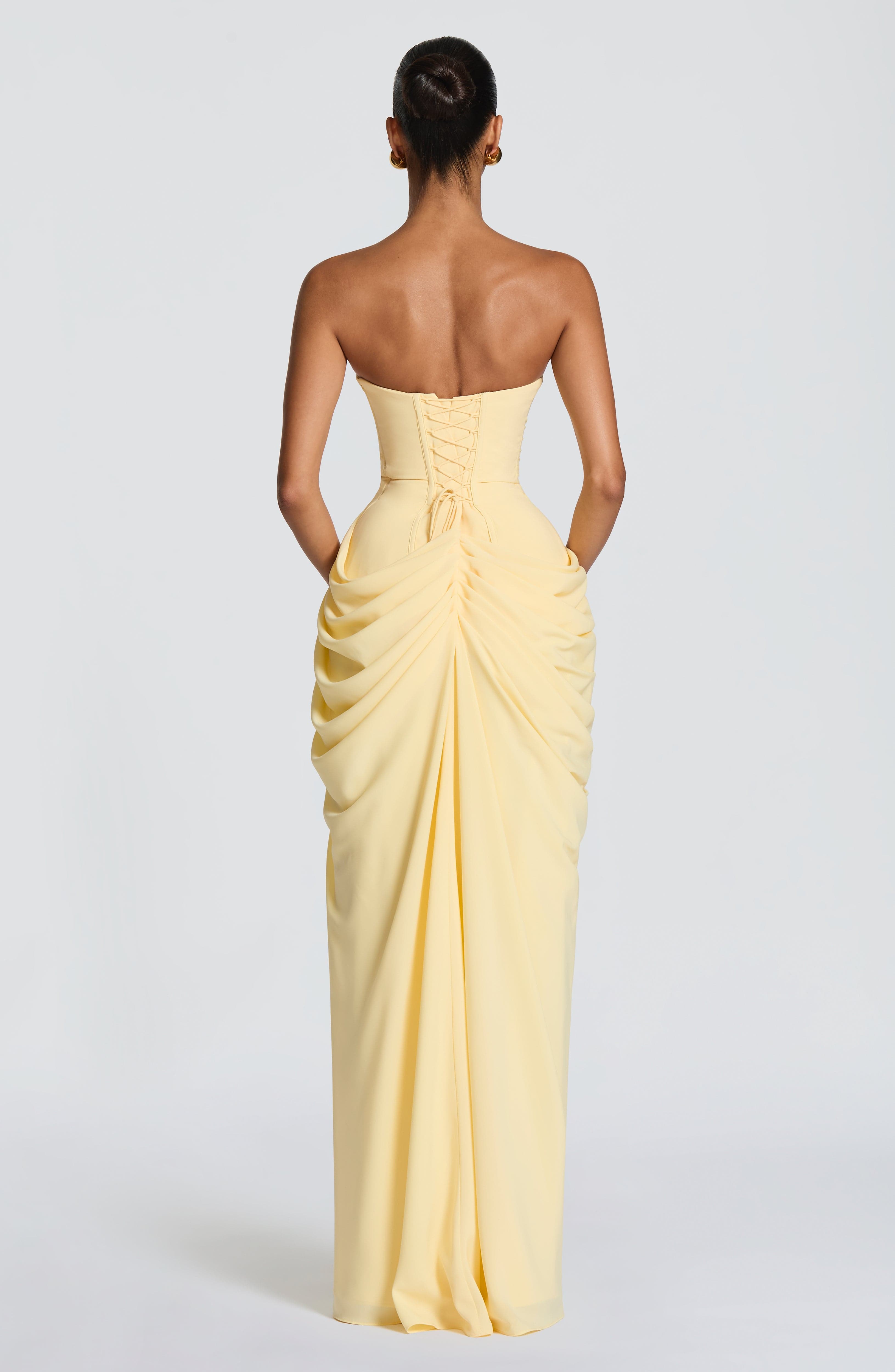 Women's strapless corset maxi dress with draped skirt and side split for formal occasions