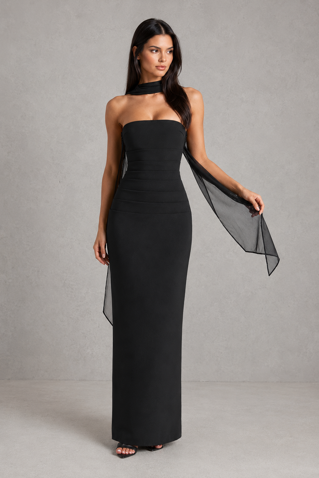 Women’s strapless maxi evening dress in premium crepe fabric featuring a pleated bodice, fitted column skirt, centre back split, and removable mesh halter strap with matching mesh scarf for versatile formal styling.